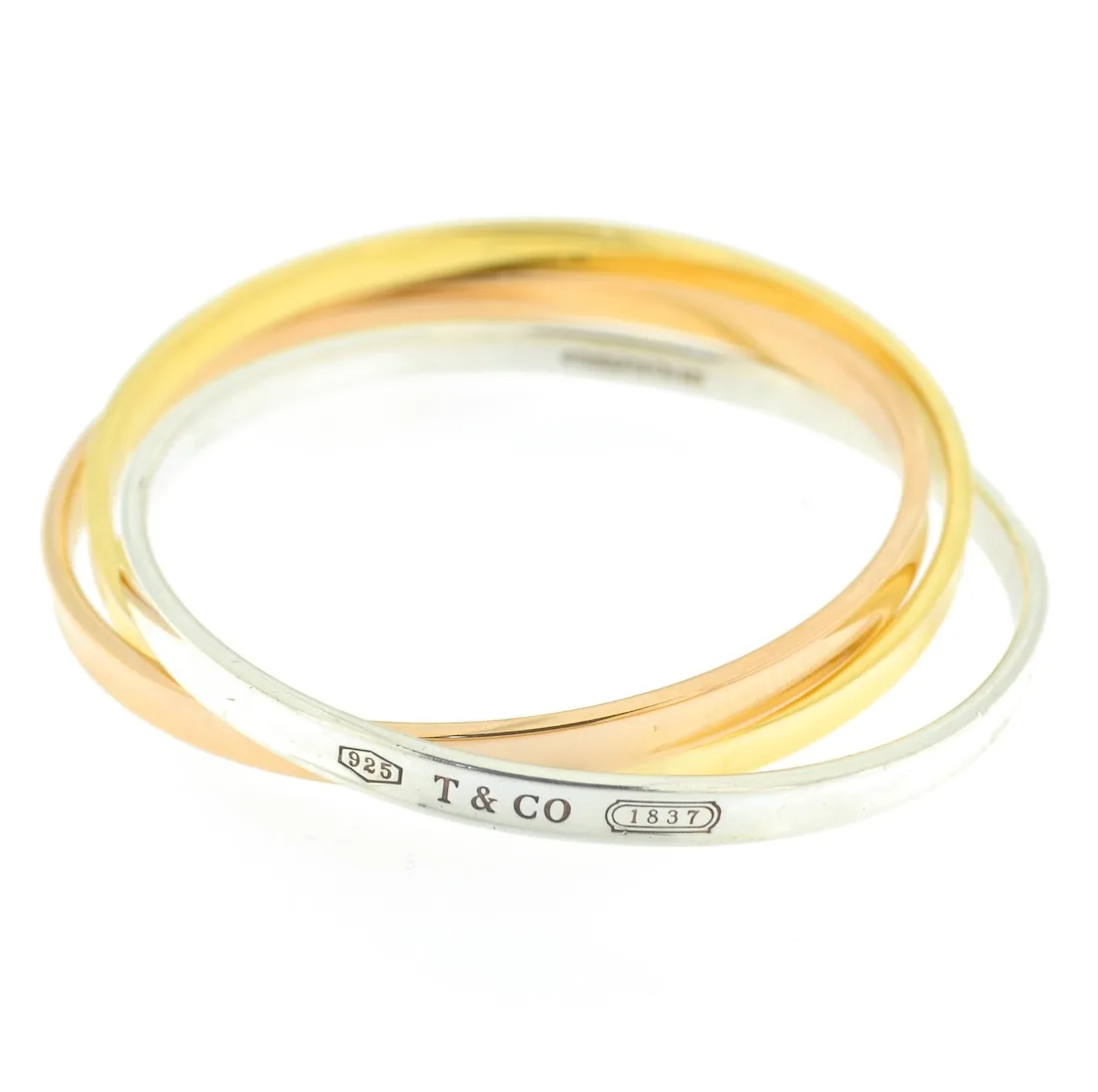 tre bracciali Tiffany intrecciati in oro giallo, oro rosa e argento.